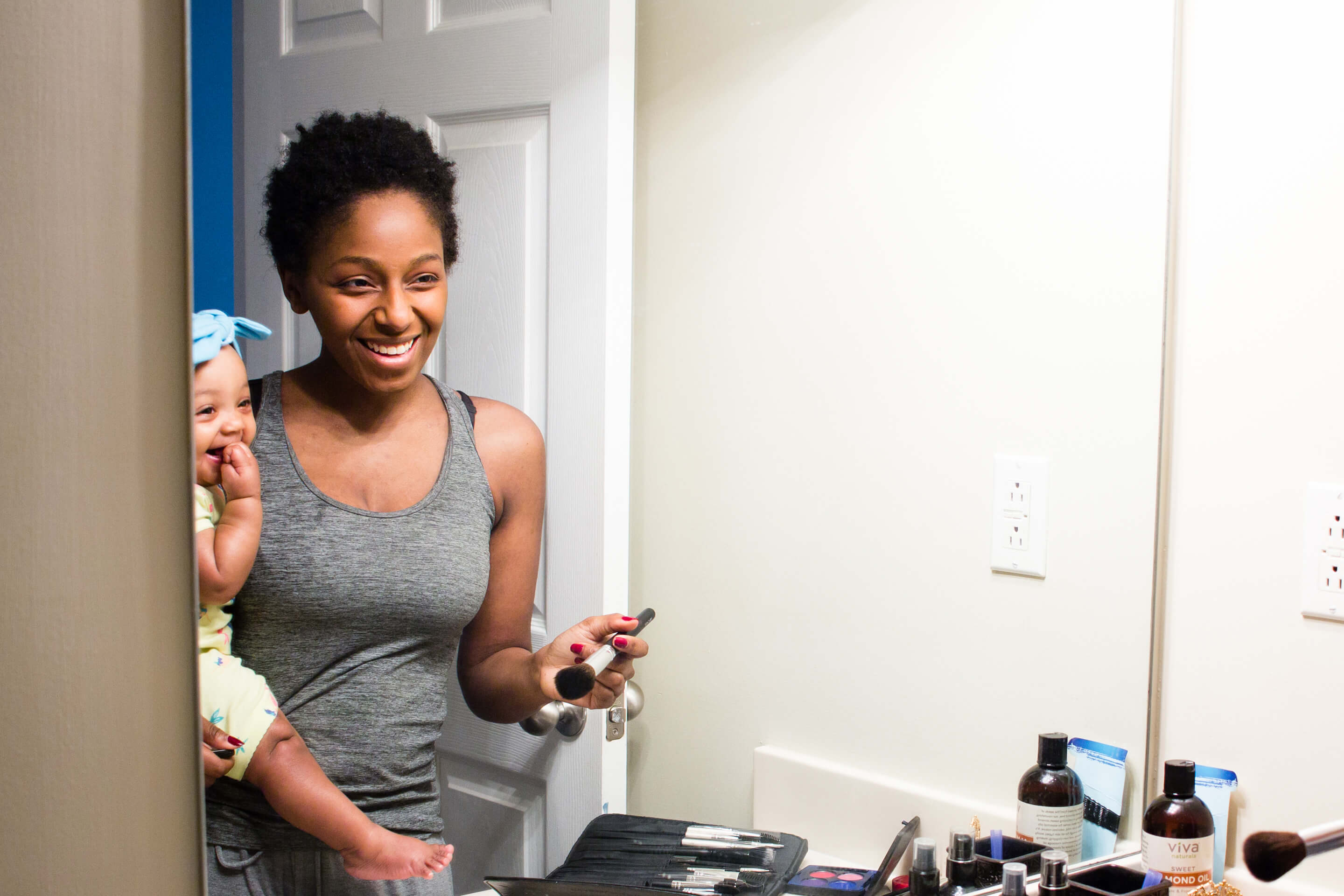 mom looking in the mirror with baby