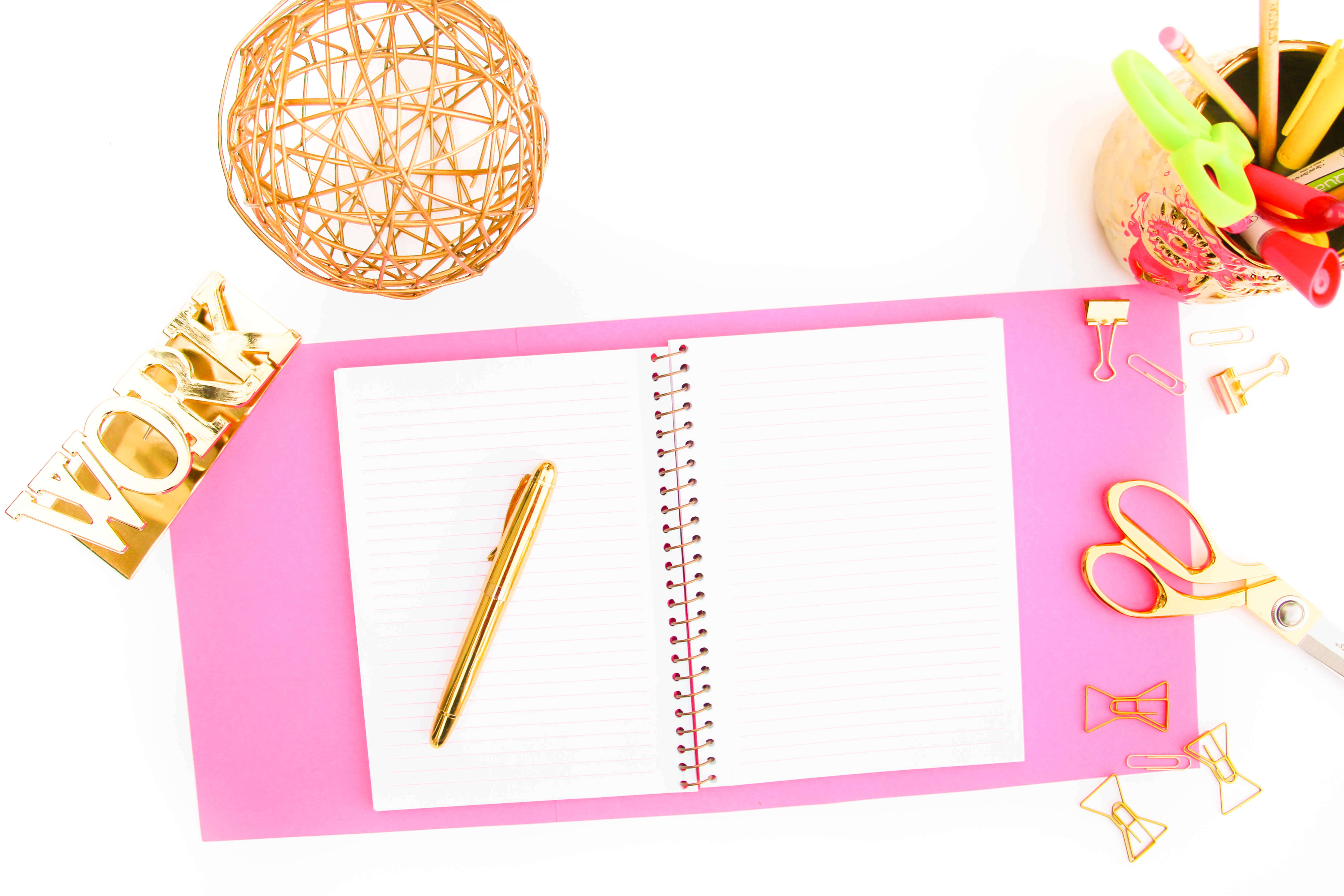 flatlay photo with notebook and pen and gold ball,dreams to reality